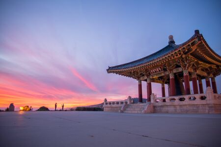 Korean Friendship Bell in San Pedro with a fiery red and purple sunset and blue sky.のeditorial素材