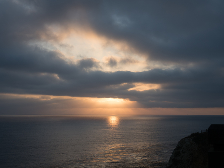 Rays of sunshine showing through a cloudy skyの写真素材