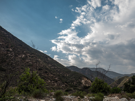 Blue cloudy sky above a valleyの写真素材
