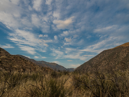 Blue cloudy sky over a valleyの写真素材