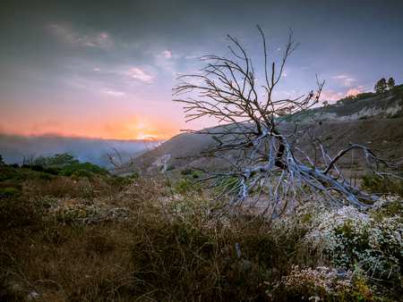 Hiking into a sunsetの写真素材