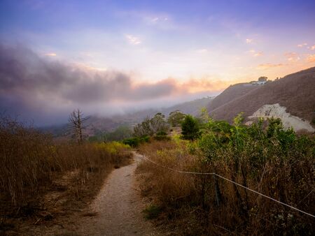 Hiking into a sunsetの写真素材