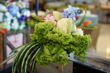 Interested flowers basket with vegetableの写真素材