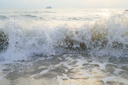 Wave and wave bubber on the sea sandの写真素材