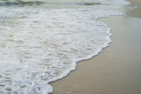 Wave and wave bubber on the sea sand