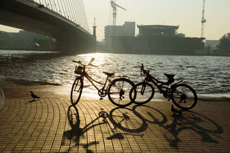 Bicicles beside the river in the morningの写真素材