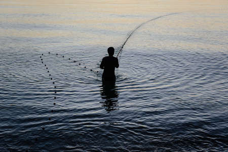 Silhouette fisherman in the morning, Thailandの写真素材
