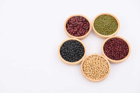 The beans are in a wooden bowl on a white background.