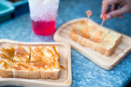Custard bread placed on a wooden tray and Red Nectarの写真素材