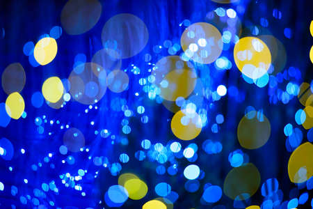 blur background, The yellow and blue bokeh of a lot. On a black backgroundの写真素材