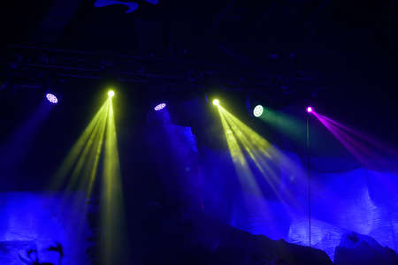The spotlights on the stage. A beautiful beam through the haze. On the black areaの写真素材