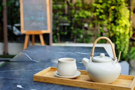 Hot tea is in the cup. Placed on a wooden tray. For a moment of rest of the day.の写真素材