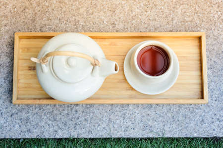 Hot tea is in the cup. Placed on a wooden tray. For a moment of rest of the day.の写真素材