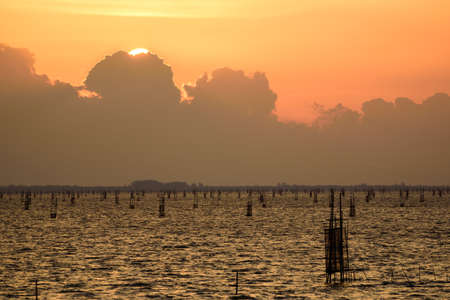 Big clouds and twilight when the sun is falling in the seaの写真素材