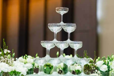 Wine glasses and beautiful flowers Was decorated for tonight's eventの写真素材