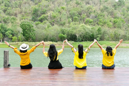 The girl raised her hand to show comfort. To relax, travel and breathe fresh air in the mountainous wide fields on holidaysの写真素材