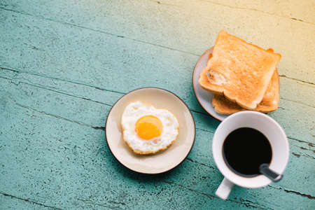 The breakfast set is placed on a blue wooden table. Ready to serve for those staying in the resort. On the morningの写真素材