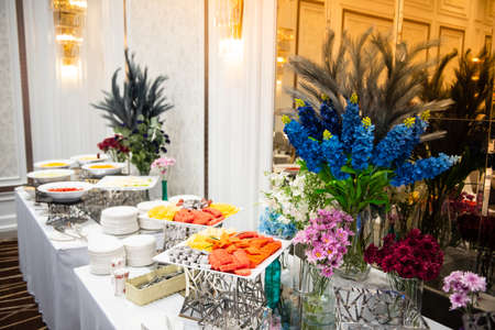 Colorful flowers Be placed Make the buffet line with snacks, salads and fruits look more beautiful