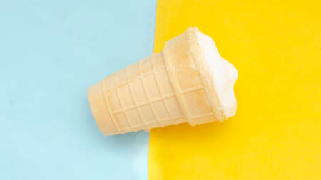 Waffle cup of cream ice cream on pastel blue yellow background.の写真素材