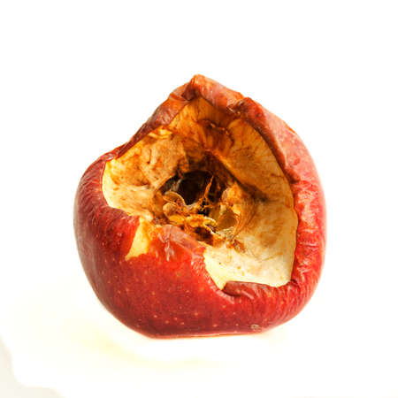 Big red bitten off and rotten apple isolated on white background.の写真素材