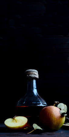 A decanter with apple cider vinegar and apple composition.の写真素材