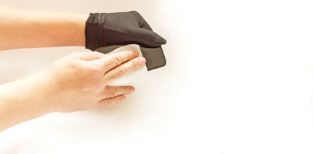 Prevention of infection.Wiping your smartphone with a cloth.の写真素材