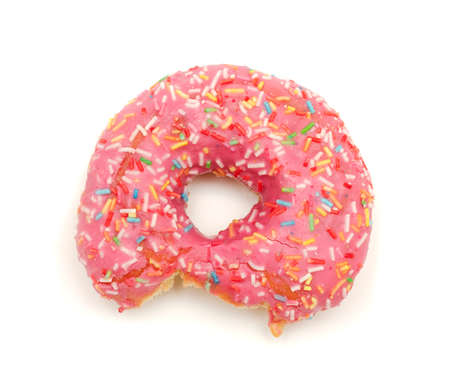 the bitten pink donut isolated on white backgroundの写真素材