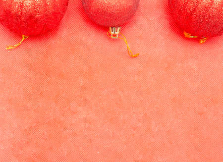 Christmas background.Three red christmas balls on red backgroundの写真素材