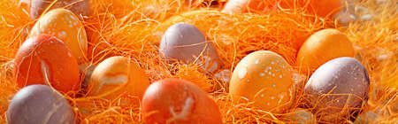 Mulicoloured Painted Easter eggs in decorative mesh.の写真素材