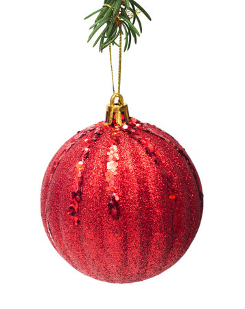 big red christmas ball is hanging on christmas tree isolated on white backgroundの写真素材