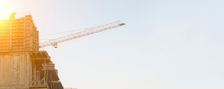 Construction site and construction crane on sunset.Banner,copyspace.の写真素材