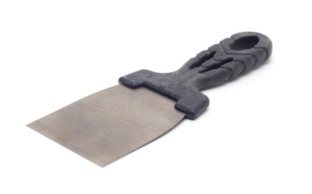 Stainless steel putty knife with ergonomic black plastic handle designed for ease of use in scraping, spreading, and finishing tasks in construction and DIY projects.の写真素材