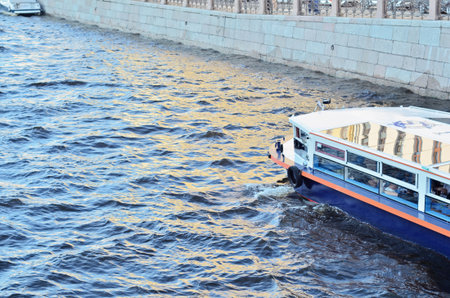 a river boat sails along the city canal.の写真素材