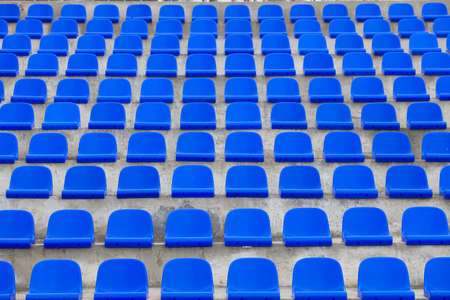 plastic blue seats on football stadiumの写真素材