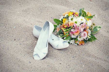 Bridal shoes and wedding bouquetの写真素材