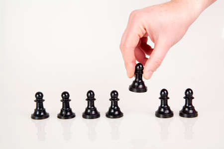 a hand taking pawn from the row の写真素材