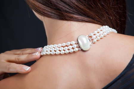Woman with pearl necklace on her neckの写真素材