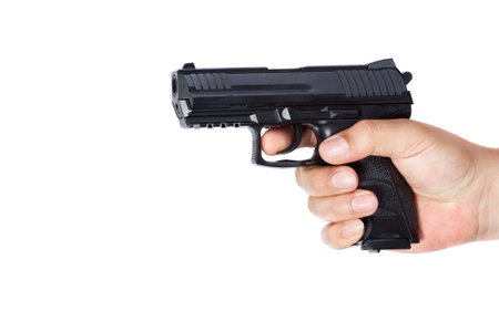 Gun in the hand isolated on white backgroundの写真素材