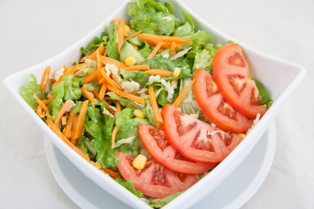 close-up of fresh vegetable salad with tomatoes and carrotsの写真素材