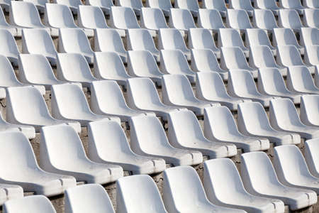 empty plastic seats on football stadiumの写真素材