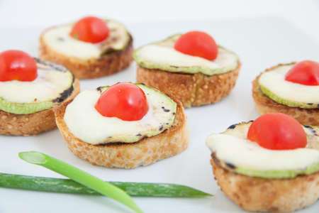 Delicious bruschetta (Italian Toasted Garlic Bread ) with zucchini, cherry tomato and mozzarellaの写真素材
