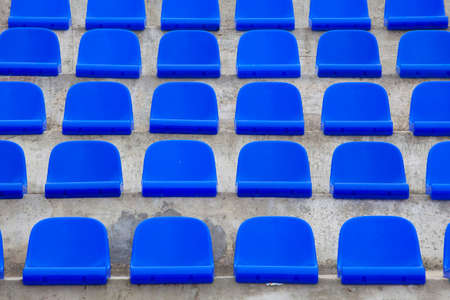plastic blue seats on football stadiumの写真素材