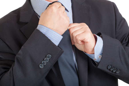 Close-up of a businessman adjusting his tieの写真素材