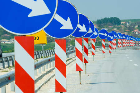 a lot of road signs showing directionsの写真素材