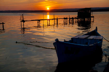 Old boat in sunset on Varna Lakeのeditorial素材