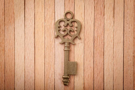 Old key on a wooden backgroundの写真素材