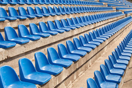 empty plastic blue seats on football stadiumの写真素材