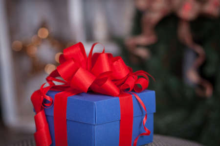 Blue gift box with red ribbon. Christmas themeの写真素材