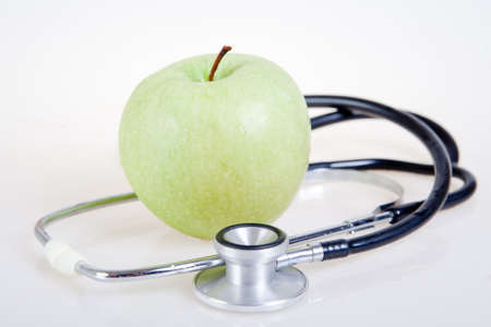 Medical stethoscope and green apple. Healty foodの写真素材
