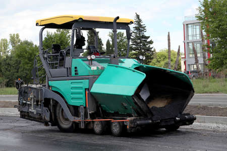 asphalt spreading machine. Road paving construction